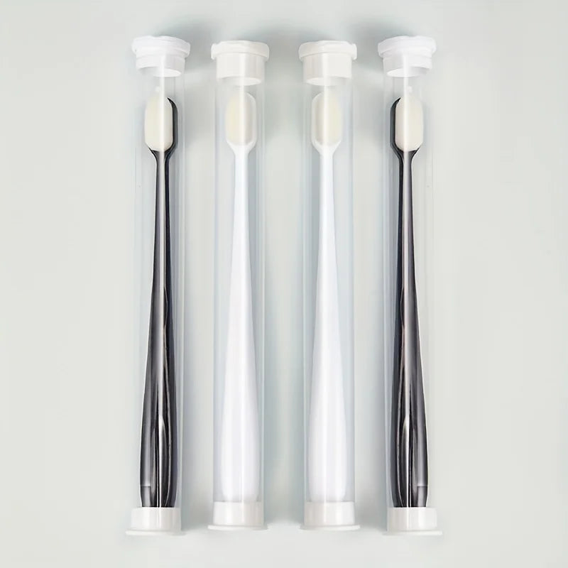 Three clear tubes of ultra-soft microbristle toothbrushes with white handles displayed vertically.