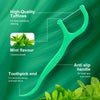 Bâton de soie vert menthe avec une touffe de feuilles de menthe, conçu pour un nettoyage interdentaire profond.