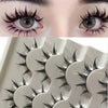 Close-up of a pair of dramatic black false eyelashes on an eye and a set of eyelash cards.