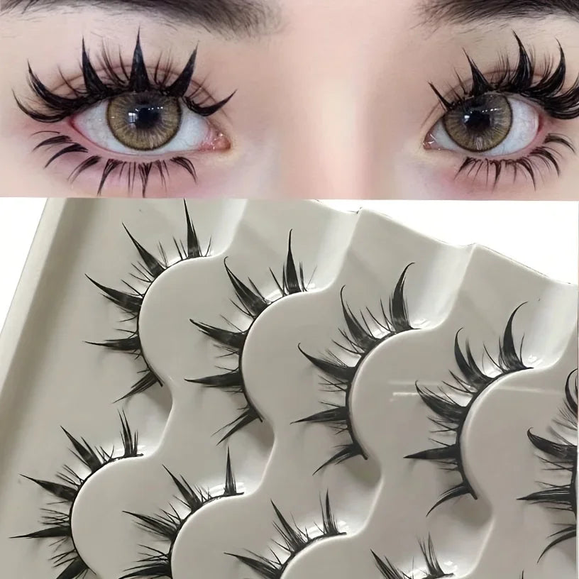 Close-up of a pair of dramatic black false eyelashes on an eye and a set of eyelash cards.