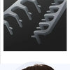 A hand is holding a black volumizing wide-tooth hair styling comb for men against a dark background.