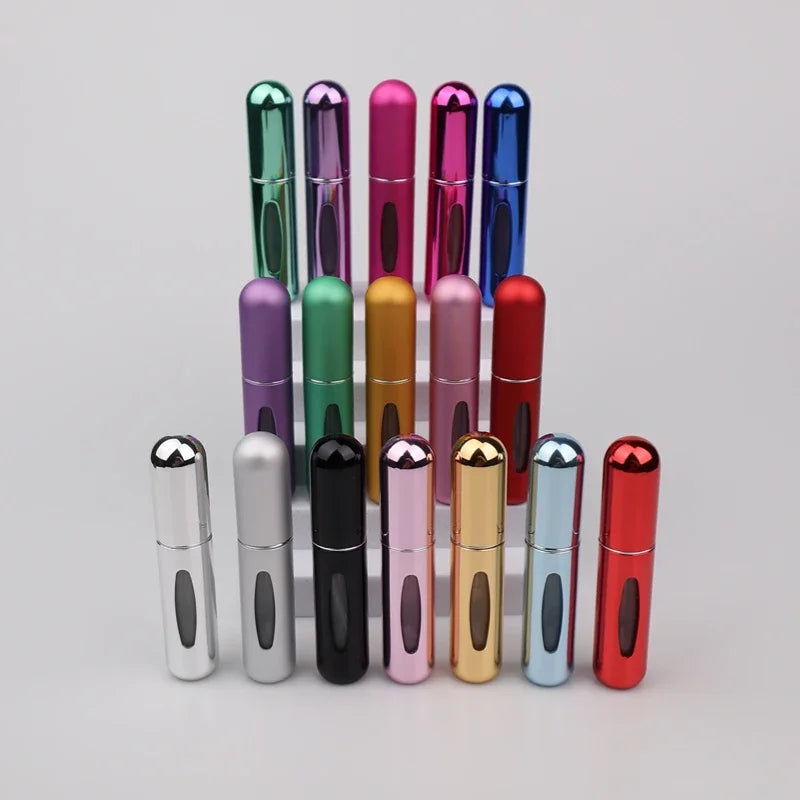 A set of five colorful 5ml travel perfume atomizer bottles in various shades including green, purple, pink, and red.