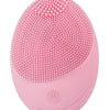A pink electric sonic facial cleansing brush with a textured silicone head.