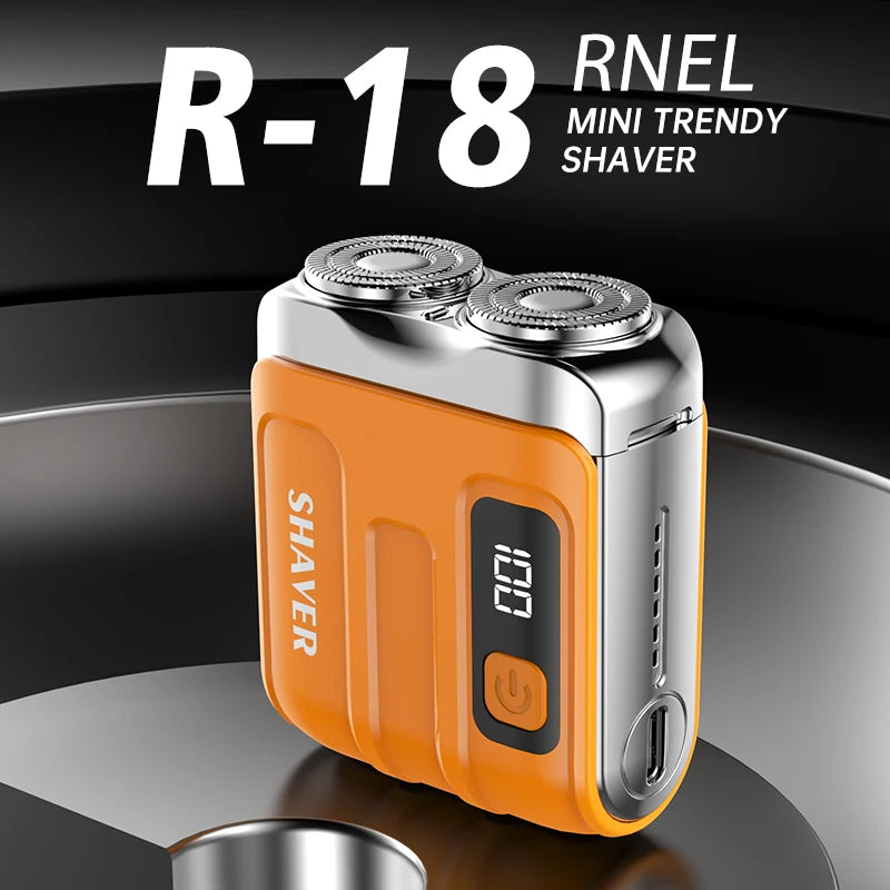 An orange and silver R-18 mini trendy shaver is shown on a dark circular surface.