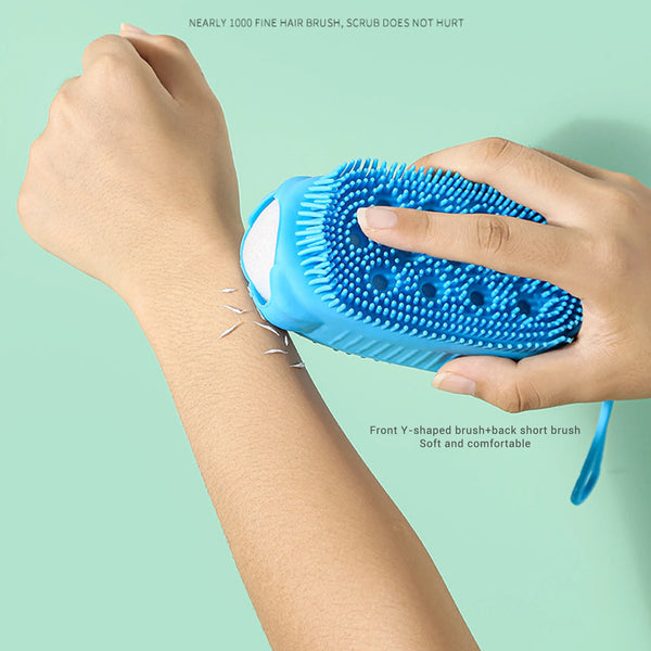 A hand is using a blue silicone body brush on an arm, demonstrating its use for gentle exfoliation.
