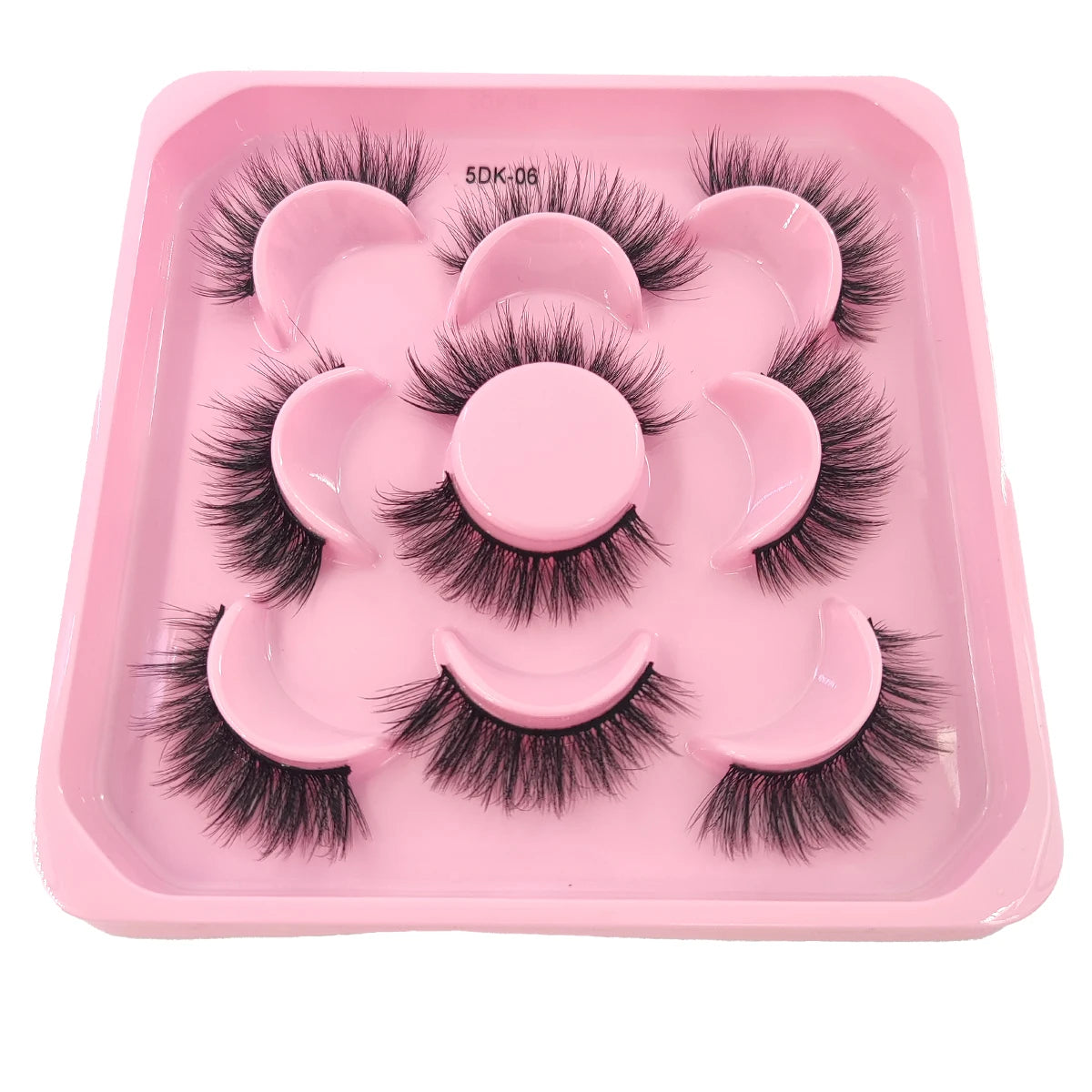 A pink tray containing a set of artificial mink eyelashes for eye extensions.