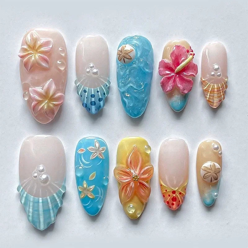 A set of 24 press-on nails featuring various pink and floral designs on an almond shape.