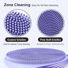 Close-up view of a purple silicone facial cleansing brush with coarse and fine bristles.