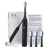 A black electric toothbrush and charging cable are shown next to its packaging box.
