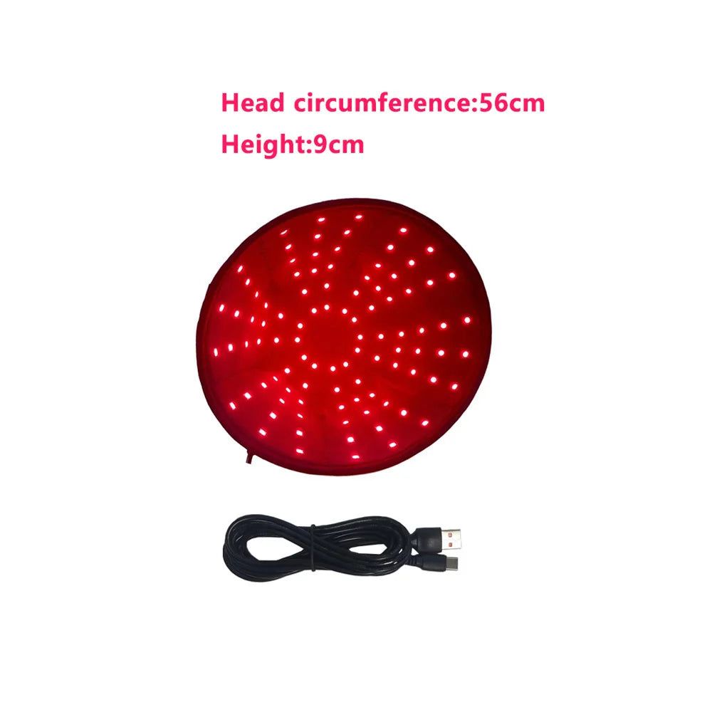 A round red light therapy cap with a visible LED pattern and an attached black cord.