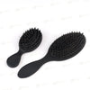 A black matte boar bristle hair extension brush set with a handle and bristles shown on a white background.