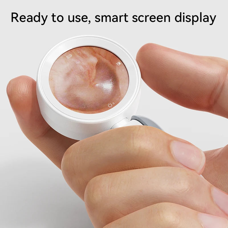 A hand holds a white smart screen display camera, showing an inspection view.