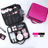 A pink portable makeup organizer bag with adjustable dividers, showing brushes and cosmetic products.