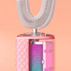 A pink automatic sonic electric toothbrush with a purple vibrating head is shown against a light orange background.