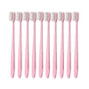 A set of ten pink ultra-fine bristle toothbrushes arranged in a row.