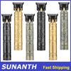 A set of five vintage cordless hair cutting and trimmer attachments in gold and black finishes.