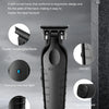 A black professional electric hair trimmer with a soft curved body and a metal blade shown against a dark background.