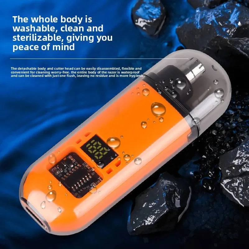 An orange and silver professional USB nose hair trimmer is shown against a dark blue background with black rocks.