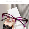 Purple cat eye reading glasses displayed on a white card against a gray background.