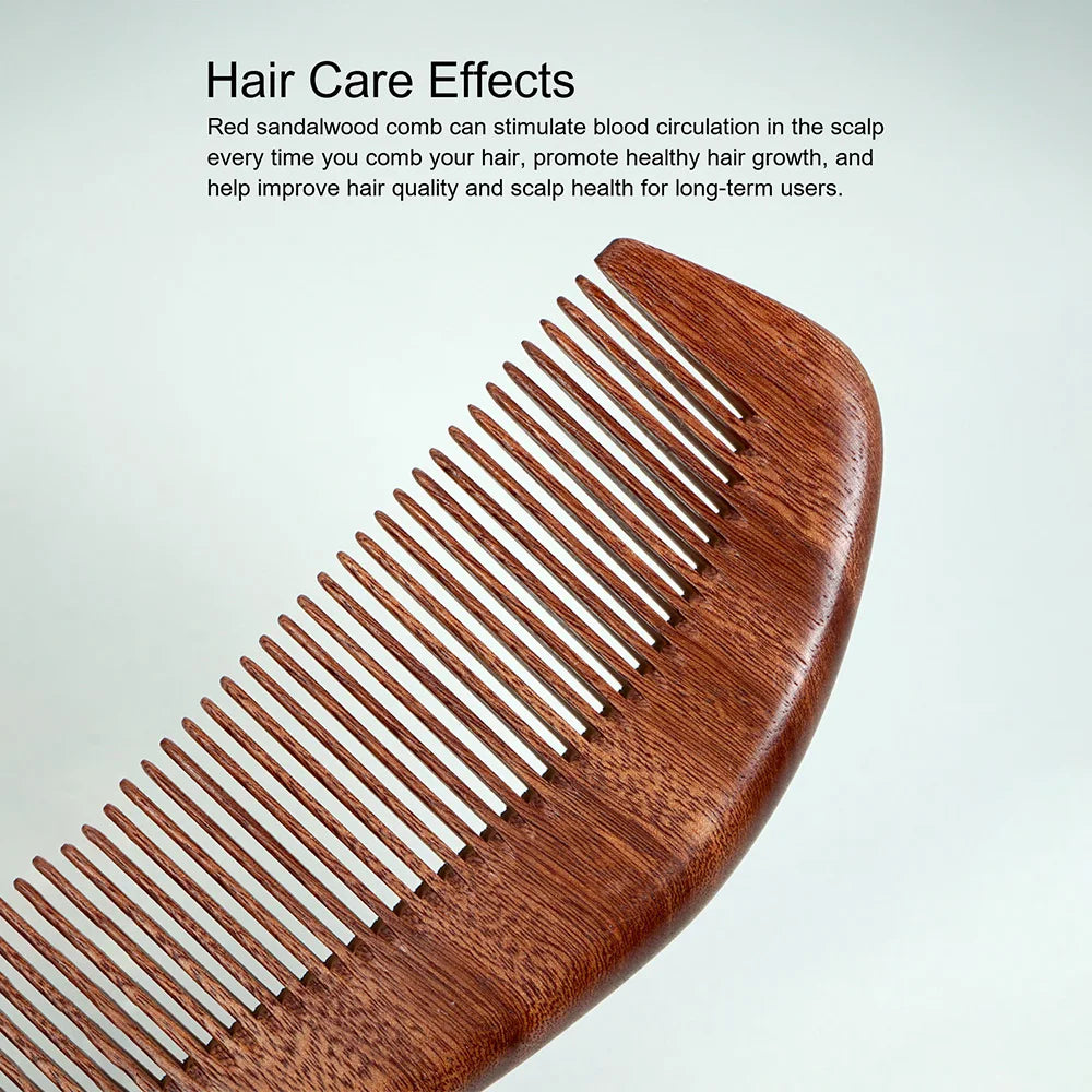 A close-up view of a reddish-brown wooden hair comb with parallel teeth.