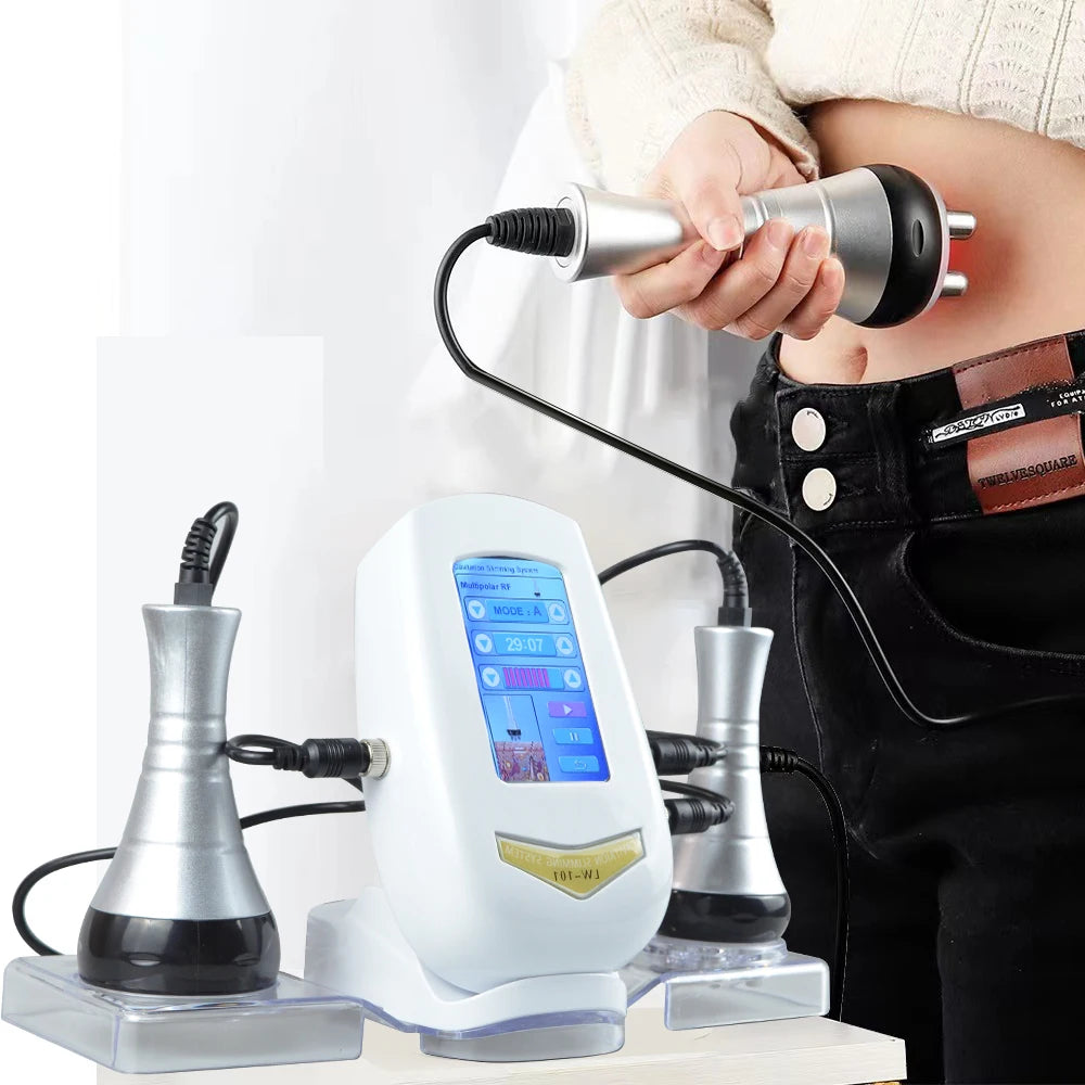 A hand is using an ultrasonic body sculpting device on a person's abdomen.