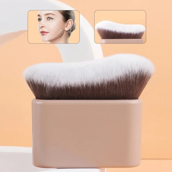 A close-up of a pro-grade contour foundation brush with angled wavy bristles shown next to a cosmetic product.