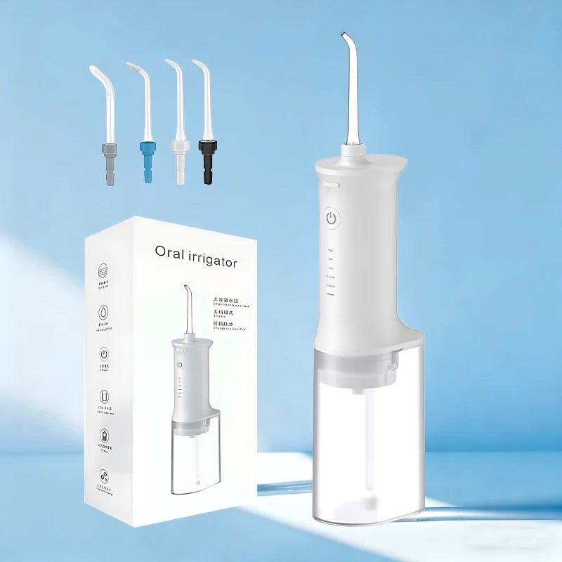 A white portable dental water flosser is shown next to various tips and packaging.