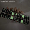 A hand displaying UV gel nail stickers with Halloween themed designs on the fingernails.
