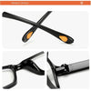 A pair of black reading glasses with orange accents shown in an X-shape and close-up views.