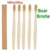A set of ten bamboo toothbrushes with natural bristles shown standing upright.