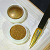A set of nail glitter powders in glass jars, featuring a gold holographic chrome finish.