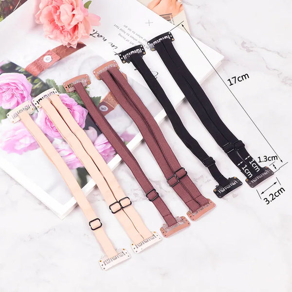 Una colección de bandas y clips para levantar el cabello ajustables en rosa, beige y negro sobre un fondo blanco.