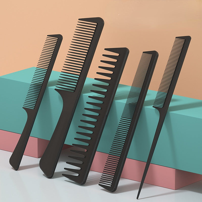 A set of black multifunctional hair detangler comb brushes displayed on a light surface.