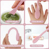 A set of pink silicone double-head face cleansing brushes shown in various uses including spatula brush, clean brush, and a f