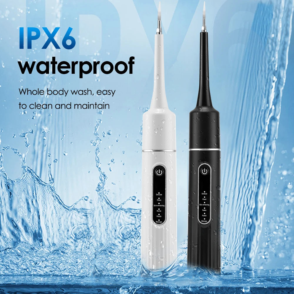 A white and black sonic electric toothbrush is shown being washed under running water.