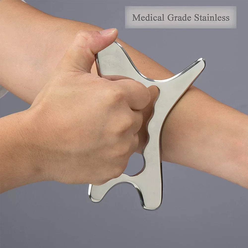A hand holds a medical grade stainless steel gua sha tool against the skin for massage or pain relief.