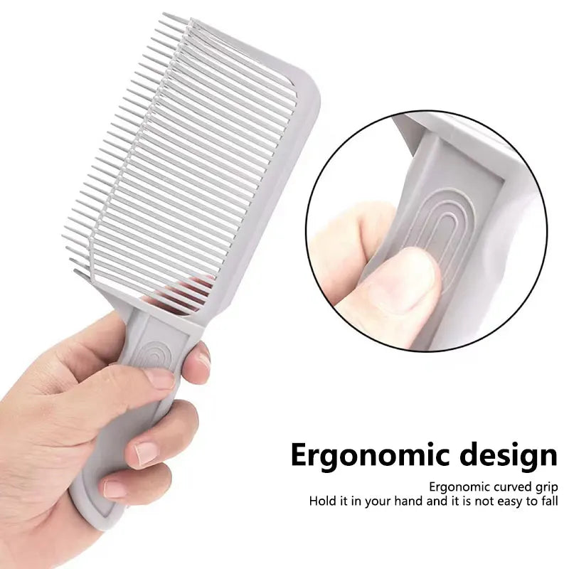 A hand holds a gray V-shaped hair cutting comb, showing an ergonomic design and close-up of the grip.