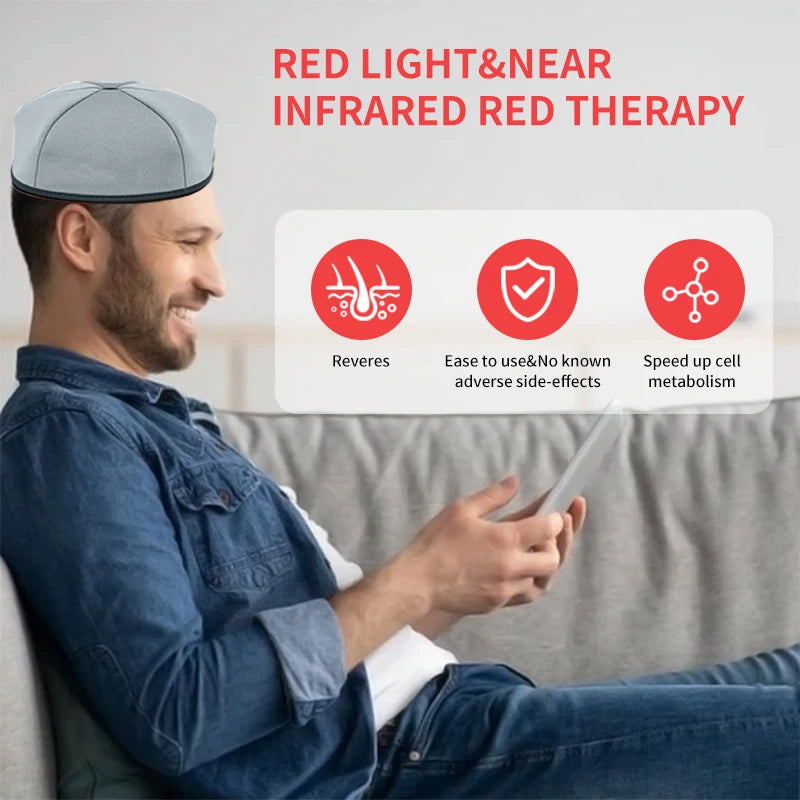 A man wearing a grey cap is using a device for red light and near infrared therapy.