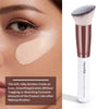 A brown makeup brush with a flat angled tip shown next to a cosmetic product.