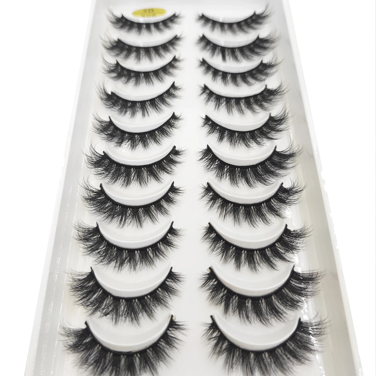 A tray of natural 3D mink false eyelashes displayed in a white plastic container.