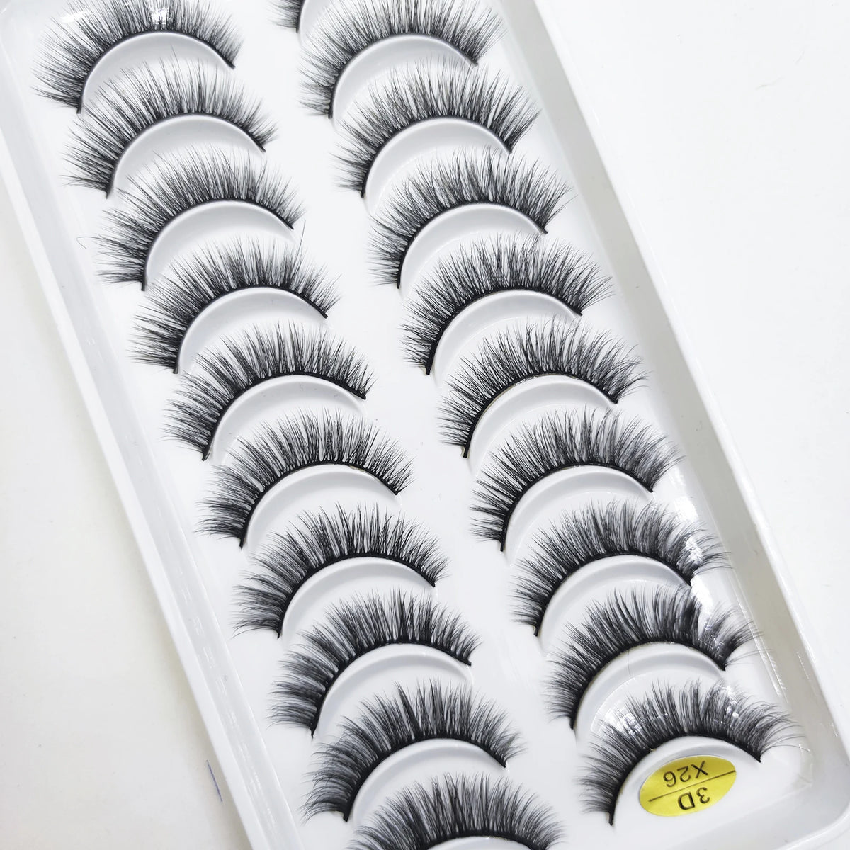 A tray of natural 3D mink false eyelashes displayed in a white packaging box.