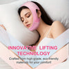 A woman is applying a pink V-Line facial lifting mask on her face while resting in bed.