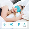 A woman is relaxing with a blue glittery gel eye mask on her eye while lying in bed.