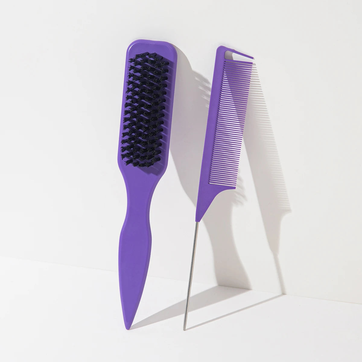 A set of two purple hair combs, one black and one lilac, displayed against a white background.