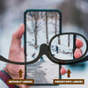 A hand holds a smartphone displaying a snowy outdoor scene, comparing the view without lenses to the view through presbyopic 