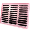 A pink plastic tray filled with numerous black lash clusters for eyelash extensions.
