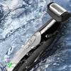 A close-up of a black electric body grooming shaver with a silver head resting on a wet, marbled surface.
