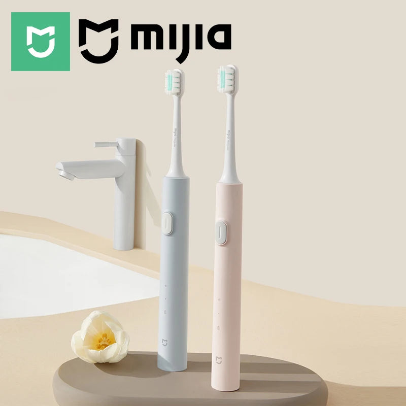 A pair of white and pink sonic electric toothbrushes are displayed on a beige surface.