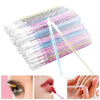 A collection of crystal lip brushes and lash spoolies in various pastel colors arranged in a fan shape.