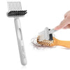 A white hair brush cleaning comb is shown with a hand using the brush component on a wooden comb.
